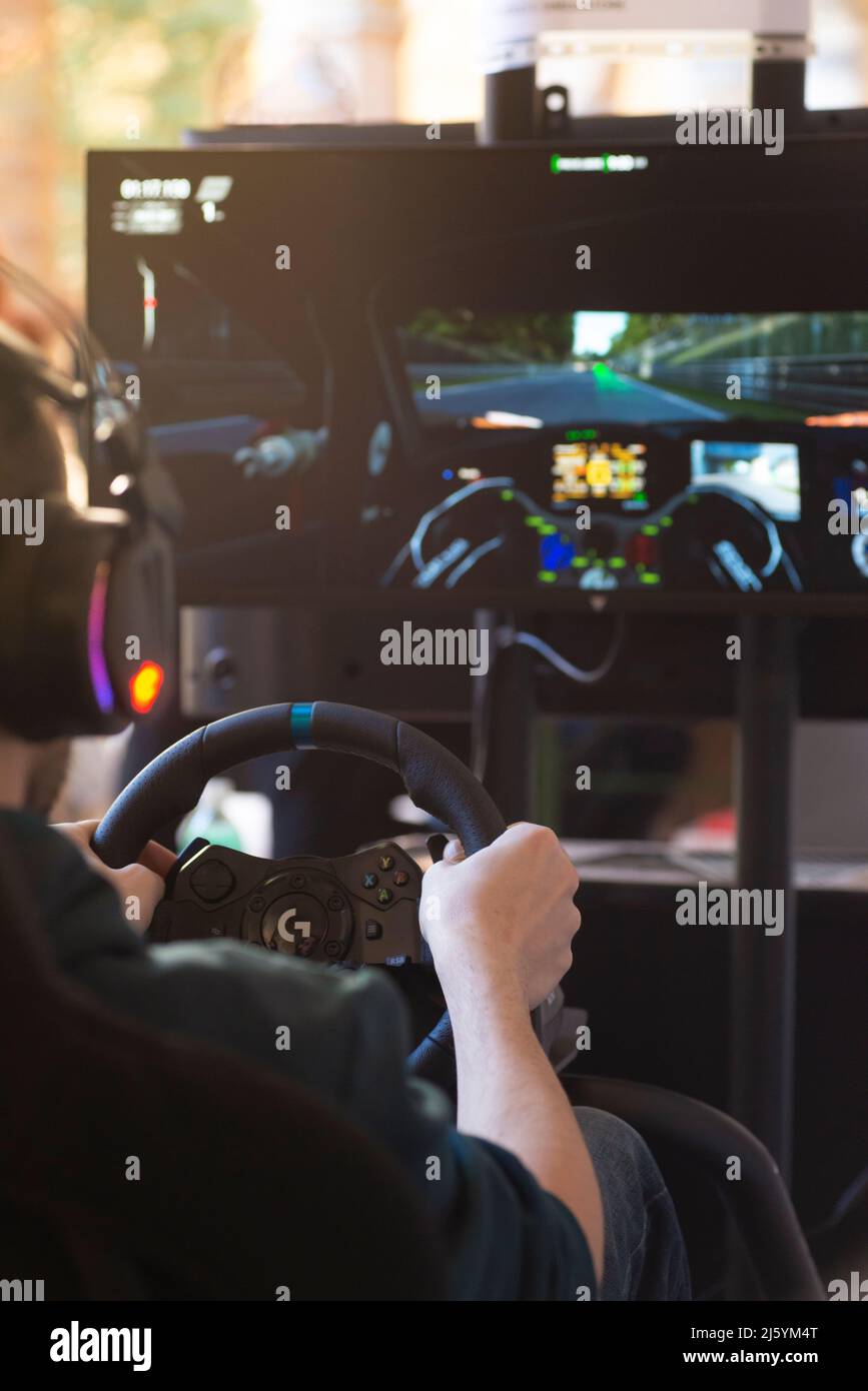 Hands of a Man on a Steering Wheel, While he Plays a Racing Game Stock Photo