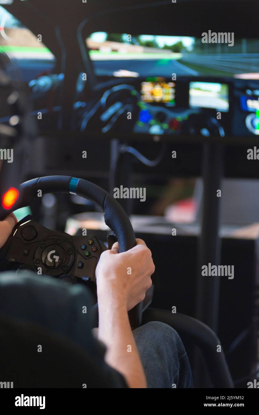 Hands of a Man on a Steering Wheel, While he Plays a Racing Game Stock ...