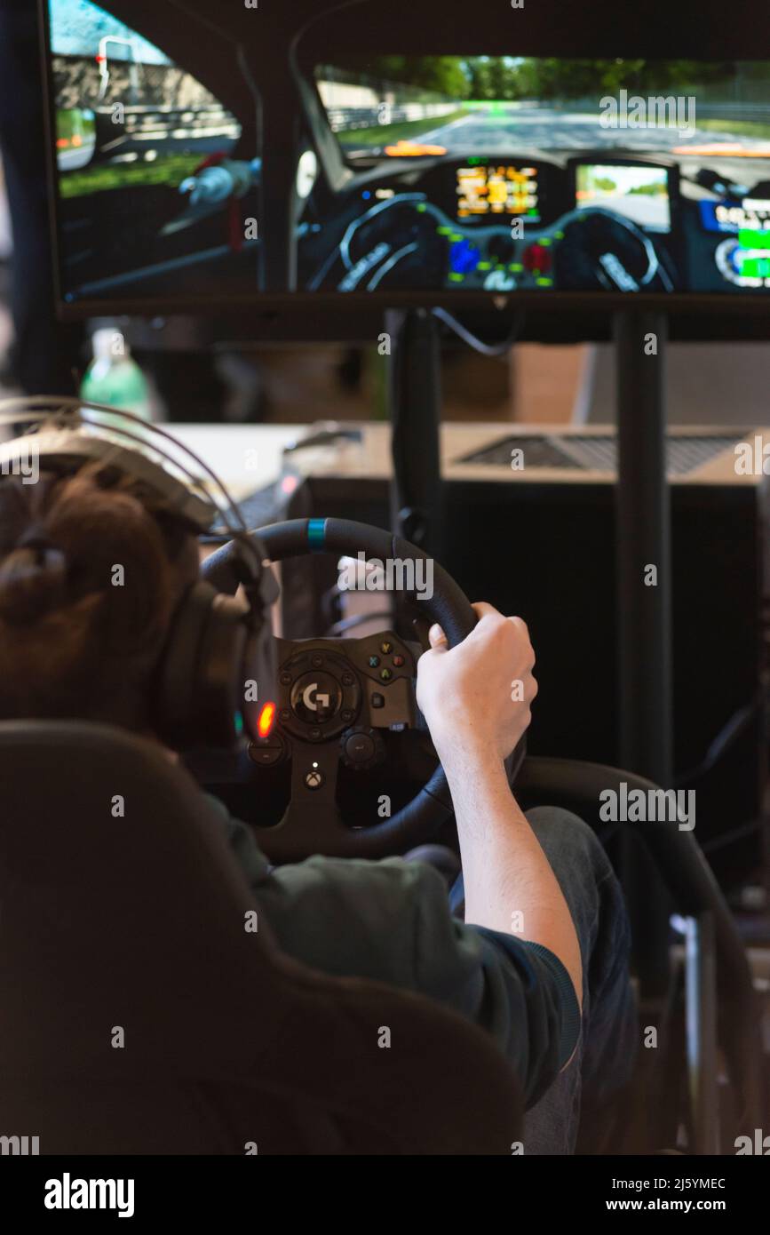 Hands of a Man on a Steering Wheel, While he Plays a Racing Game Stock ...