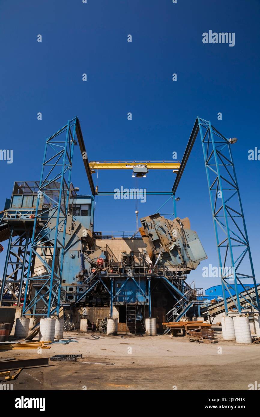Partial view of an industrial metal shredder at a scrap metal recycling yard. Stock Photo