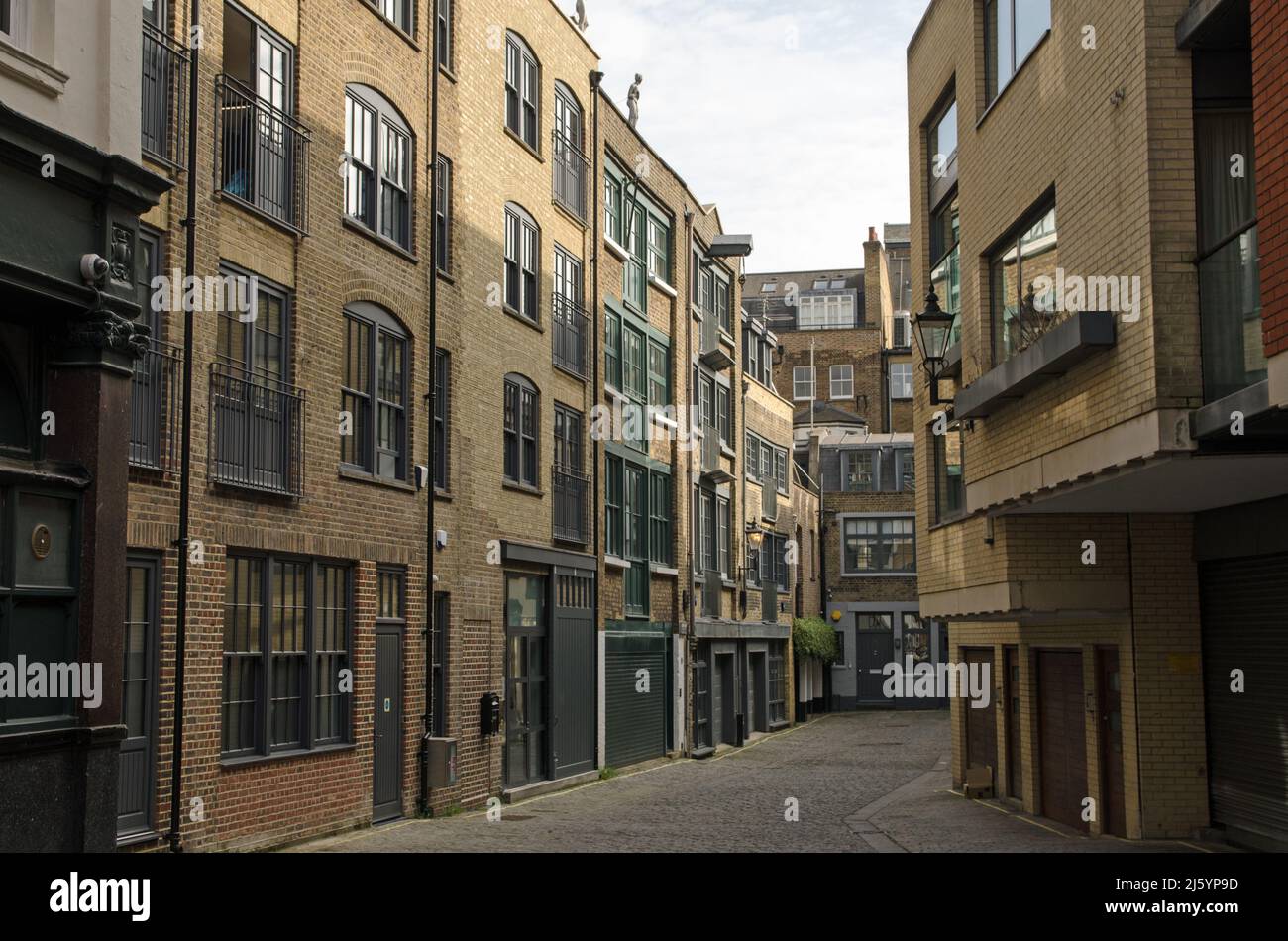 The historic mews Bourtlet Close in the Fitzrovia district of Westminster, Central London.  The buildings used to be warehouses and are now smart offi Stock Photo
