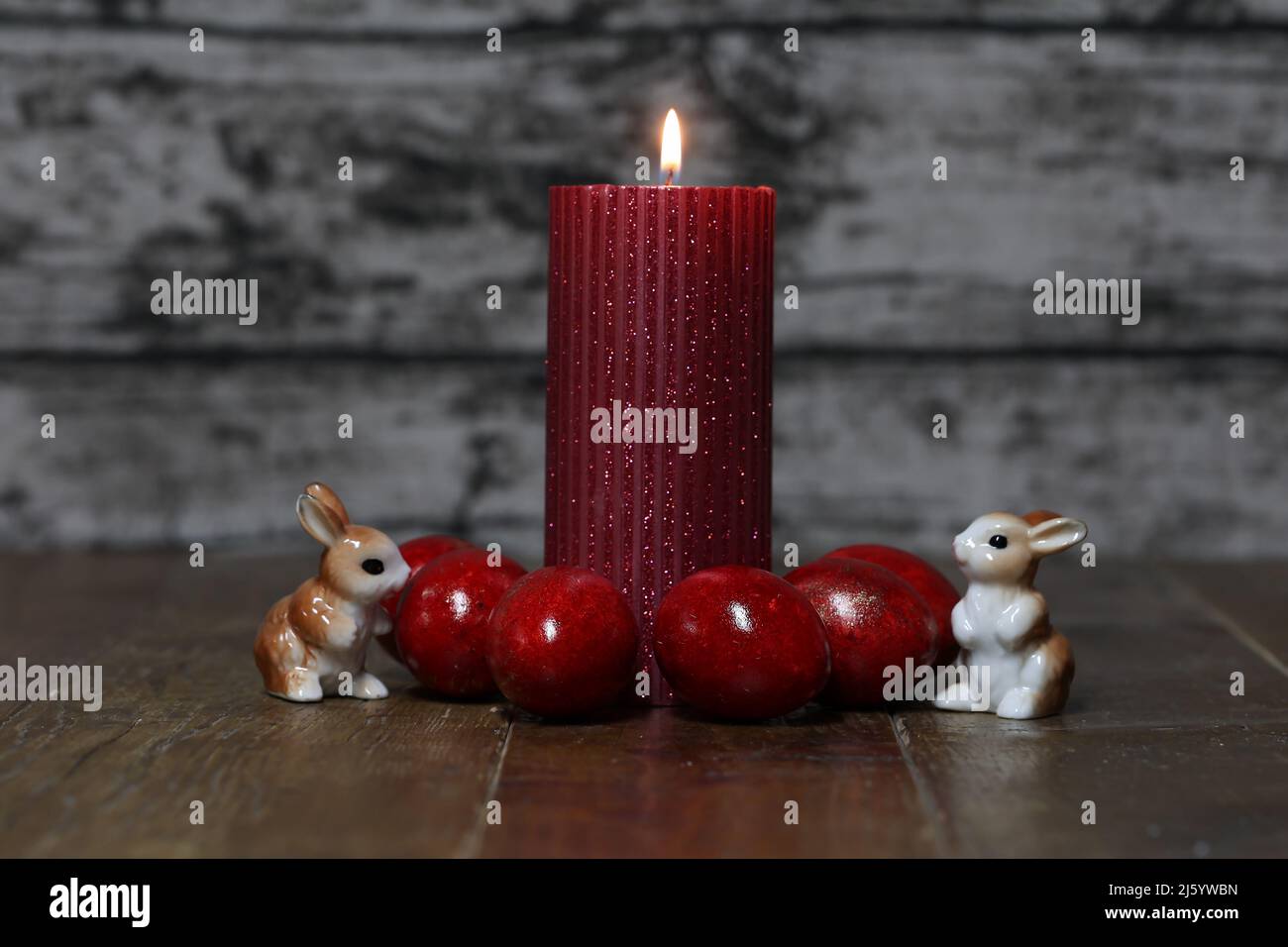 Festive composition with Easter eggs and candles. Stock Photo
