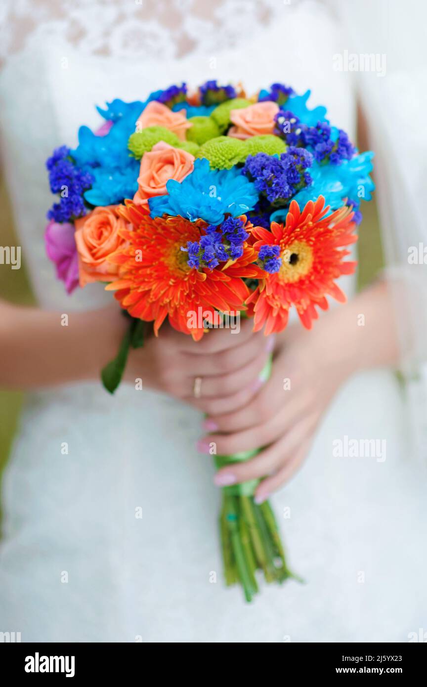 Bright multicolored bridal bouquet close up in the hands of bride. Mexican  wedding. A beautiful bouquet in blue, purple, orange, cream, pink, green hu  Stock Photo - Alamy, image size:864x1390