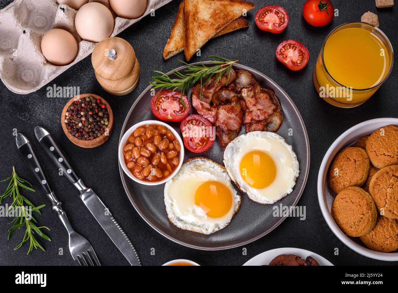 A delicious nutritious healthy breakfast with fried eggs, bacon, beans