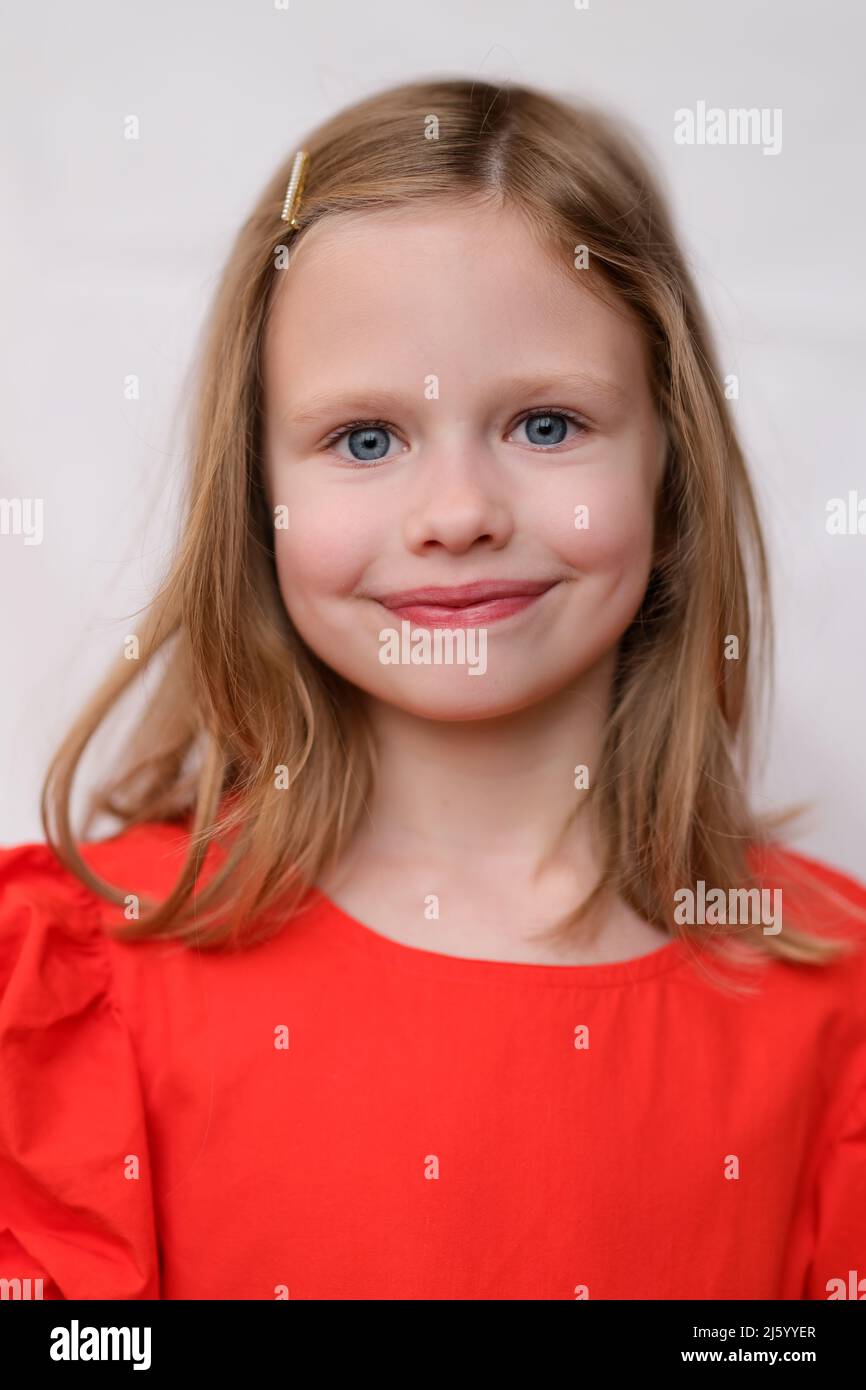 Portrait of beautiful smiling little girl in red dress Stock Photo - Alamy