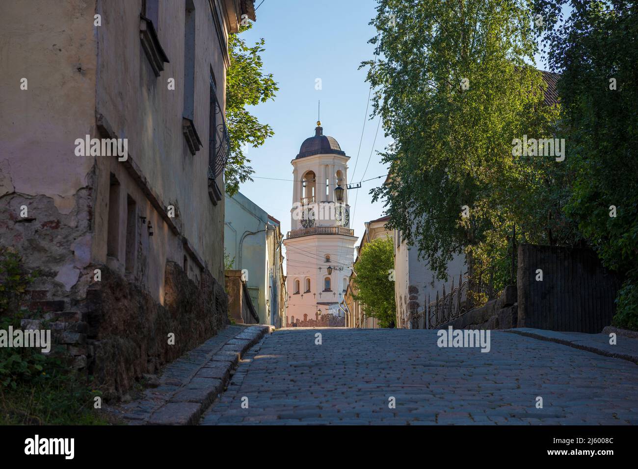 View of the ancient Clock Tower from Vodnaya Zastava street on a sunny August evening. Vyborg, Russia Stock Photo