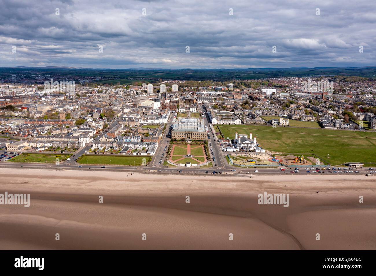 Ayr, Scotland, UK. 26th Apr, 2022. PICTURED: Aerial drone view looking down from above of Ayr Beach taking in views of the Firth of Clyde and the seaside town of Ayr. West of Scotland saw bright sunshine and blue sky at the seaside on Ayr Beach. People out walking and a horse rider takes their horse through a gallop in the cool sea water. Credit: Colin Fisher/Alamy Live News Stock Photo