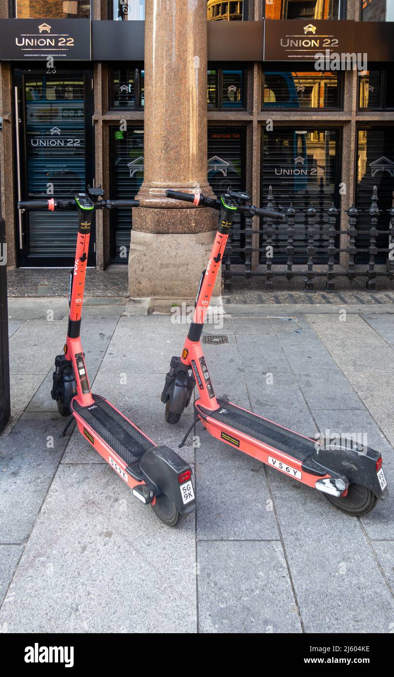 Two Voi e-scooters in Liverpool City Centre Stock Photo