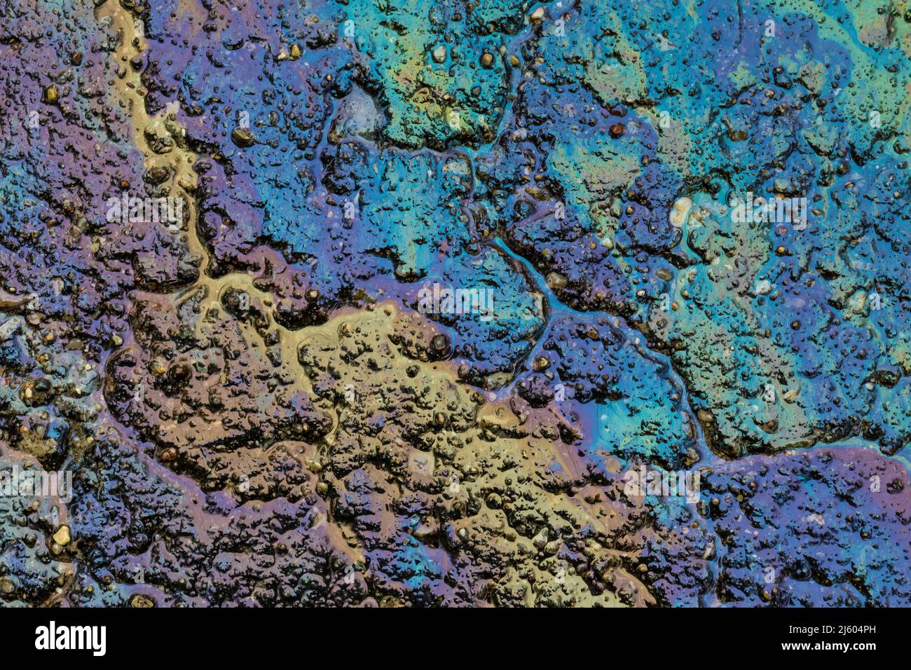Oil sheen originating from a truck's hydraulic fluid on asphalt in