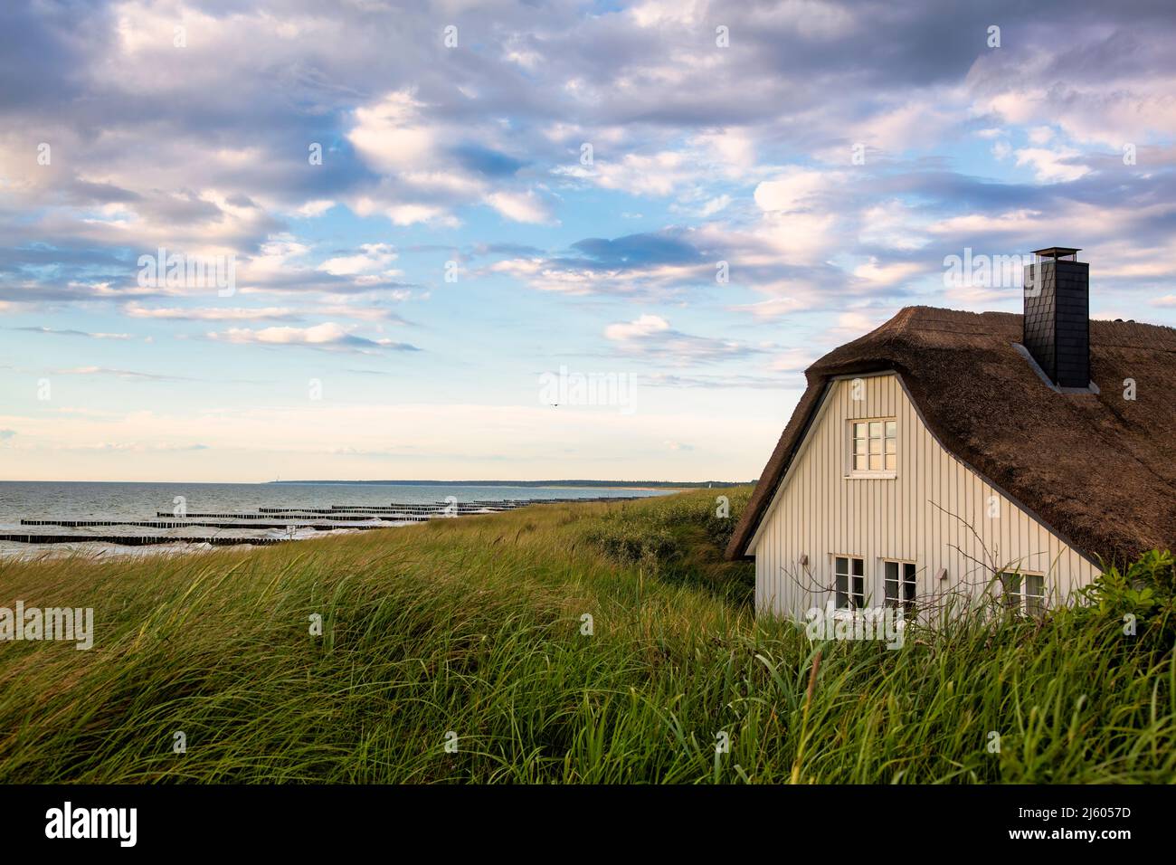 Traditional beach house behind the sand dunes near the Baltic Sea Stock Photo