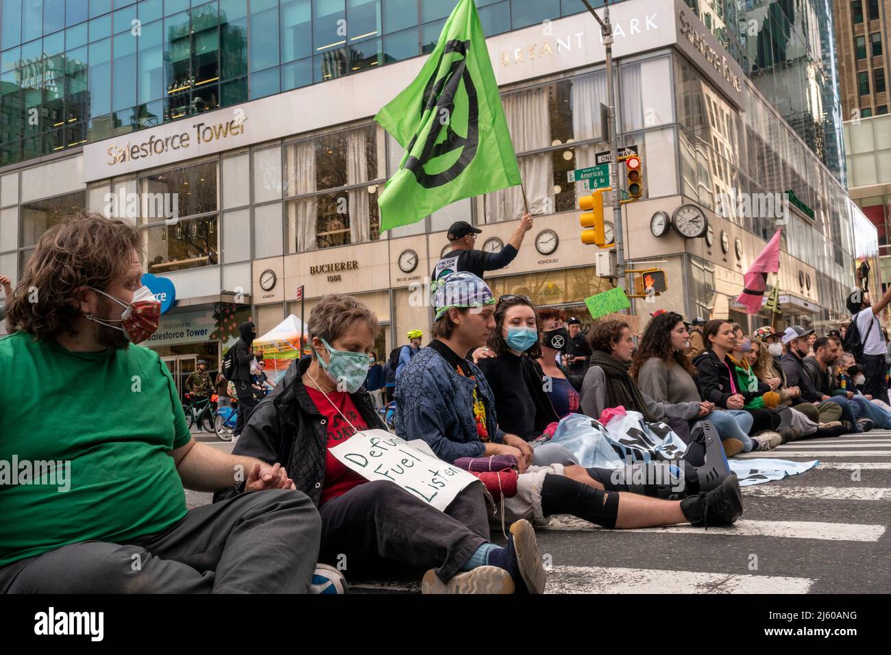 Environmental activists affiliated with Extinction Rebellion perform civil disobedience by blocking traffic on Sixth Avenue in New York on Saturday, April 23, 2022. The protest called attention to the inactivity of government to stop climate catastrophe, the protesters were subsequently arrested(© Richard B. Levine) Stock Photo