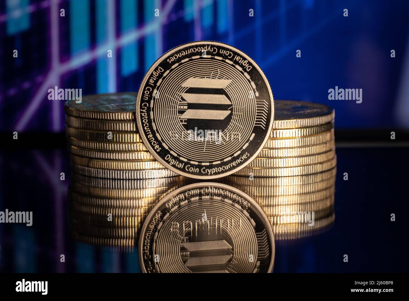 Solana SOL cryptocurrency physical coin and blurry price charts Stock Photo  - Alamy