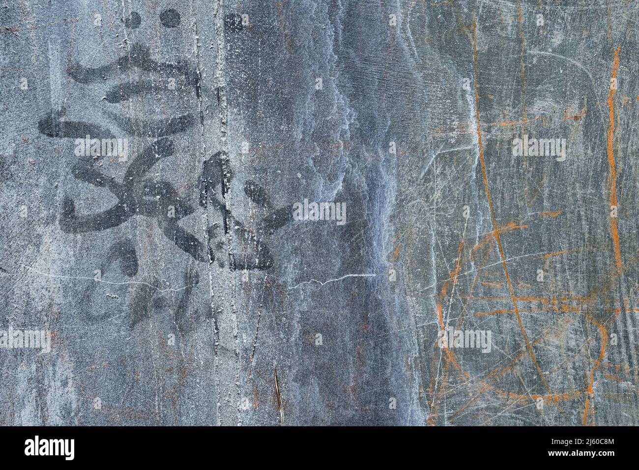Old multi colored cement wall scribble markings, cracks, and crevices Stock Photo
