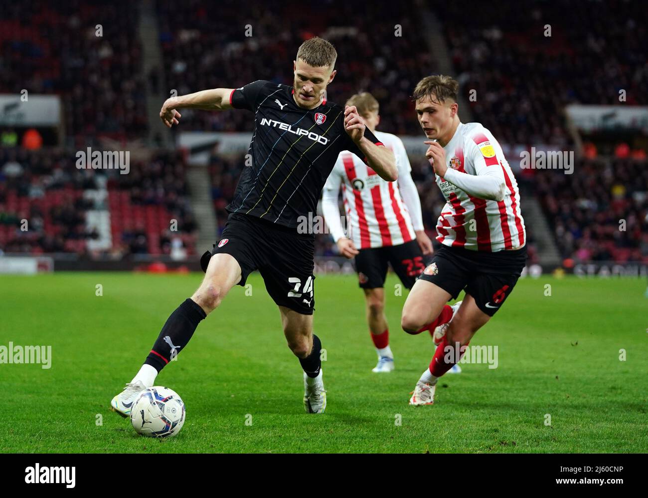 Rotherham United's Michael Smith (left) and Sunderland's Callum Doyle battle for the ball during the Sky Bet League One match at the Stadium of Light, Sunderland. Picture date: Tuesday April 26, 2022. Stock Photo