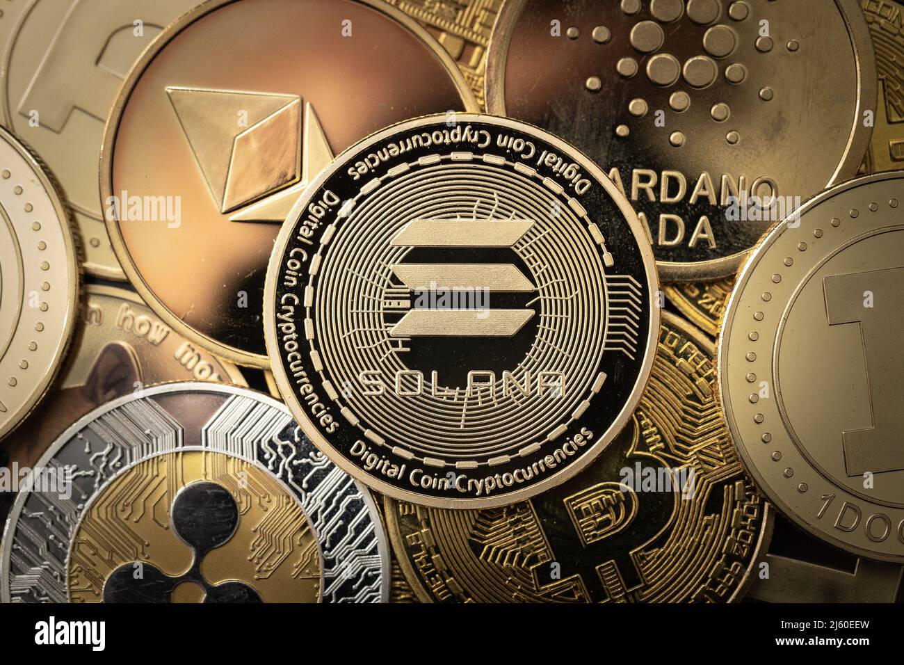 Solana SOL cryptocurrency physical coin on top of other cryptocurrencies. Stock Photo