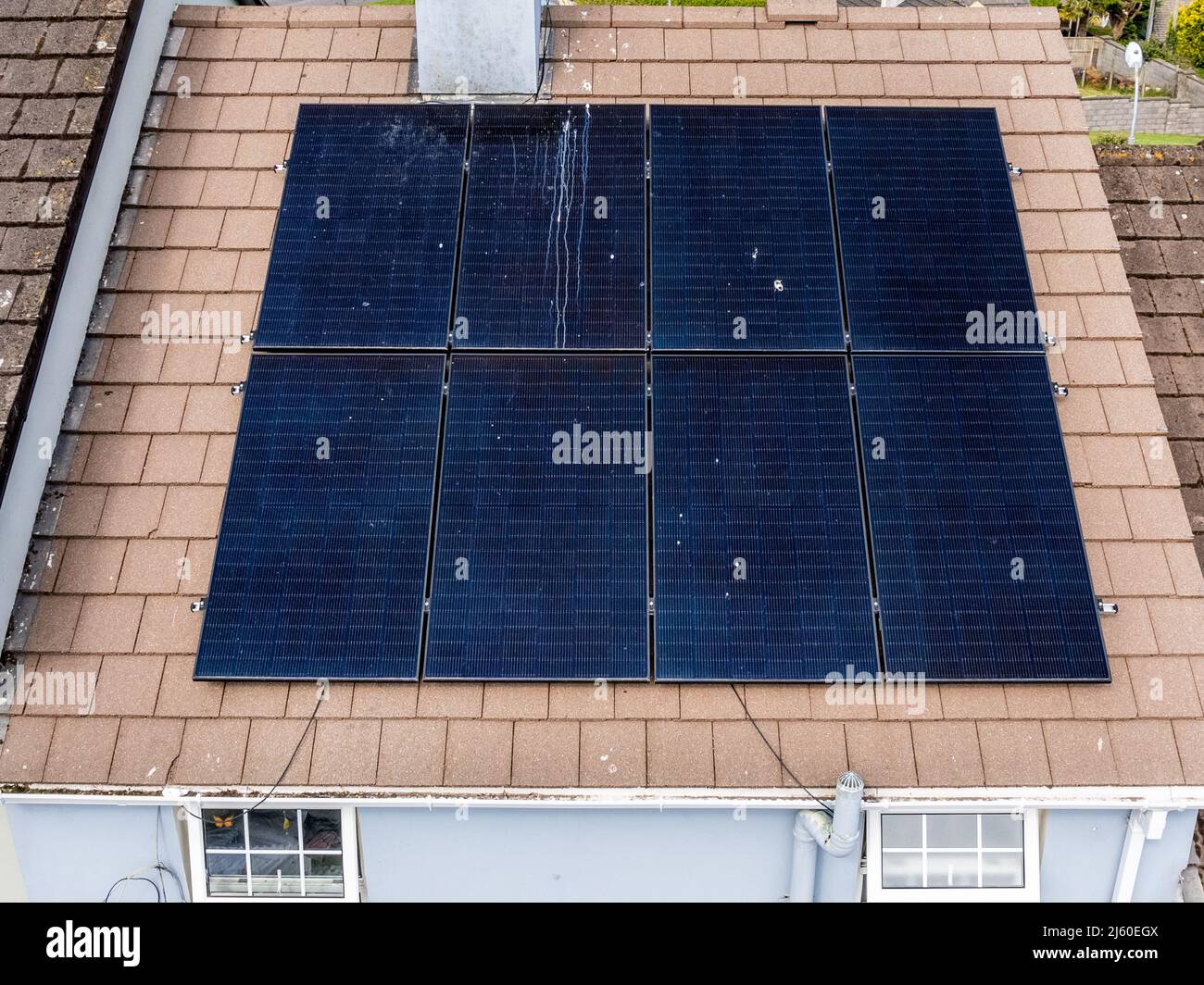 Eight electric solar panels on the roof of a domestic house in West Cork, Ireland. Stock Photo