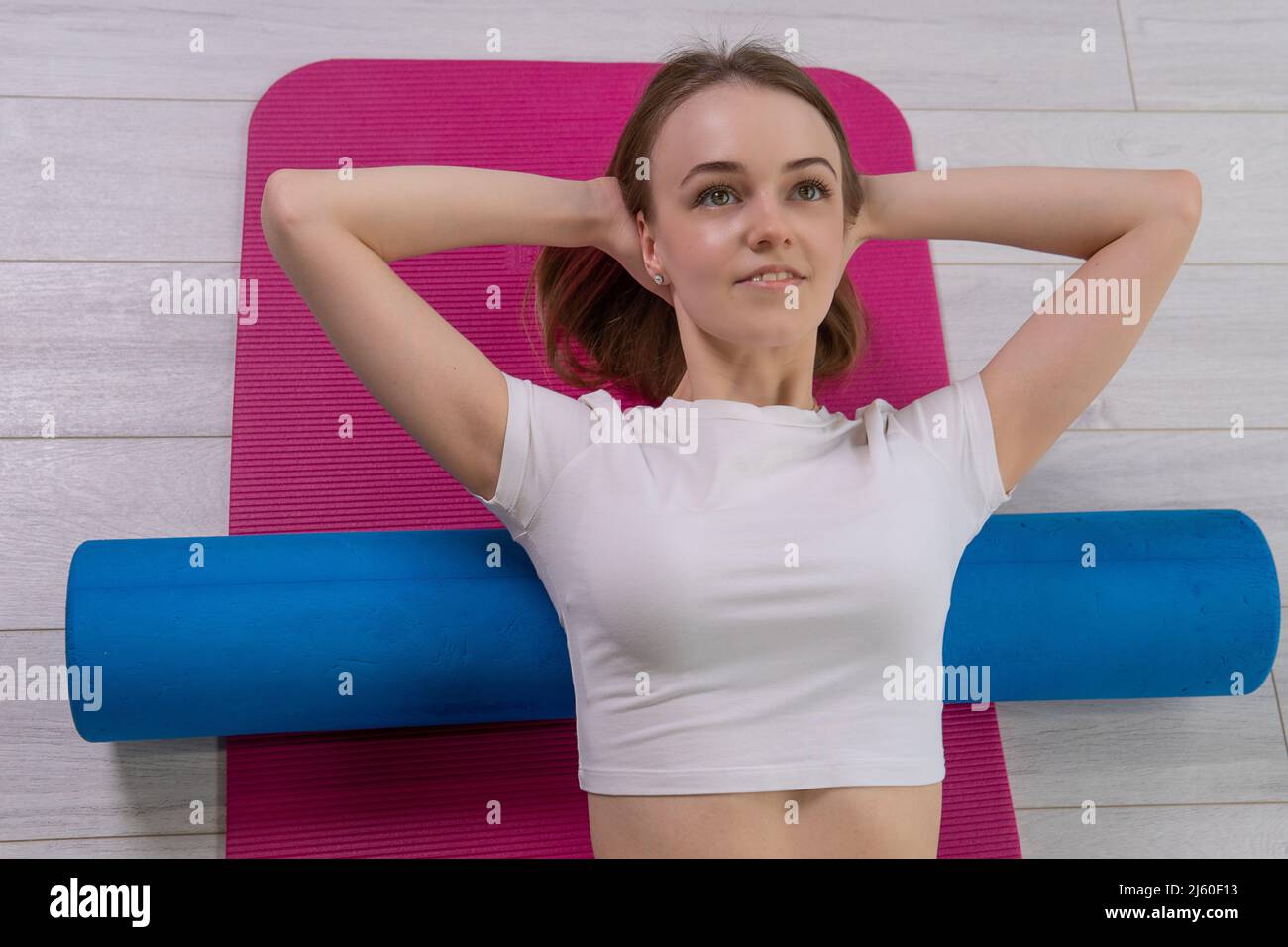 Fitness mfr lies the the roller girl on red mat mfr sportswear, from