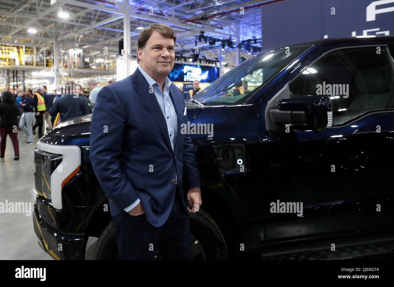 Ford CEO Jim Farley poses next to a model of the all-new Ford F-150 Lightning electric pickup truck at the Ford Rouge Electric Vehicle Center in Dearborn, Michigan, U.S. April 26, 2022. REUTERS/Rebecca Cook Stock Photo