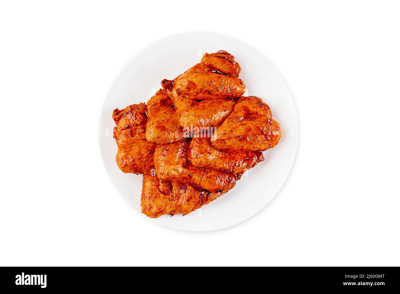 Marinated chicken wings in red sauce on isolated white background.Top