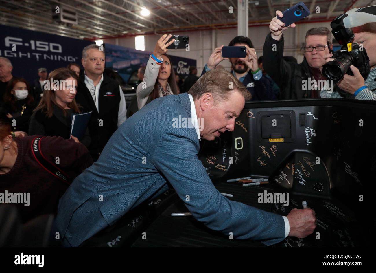 Ford Motor Executive Chairman Bill Ford signs a “frunk”, the front truck area, of the all-new F-150 Lightning electric pickup truck at the Rouge Electric Vehicle Center in Dearborn, Michigan, U.S., April 26, 2022. REUTERS/Rebecca Cook Stock Photo