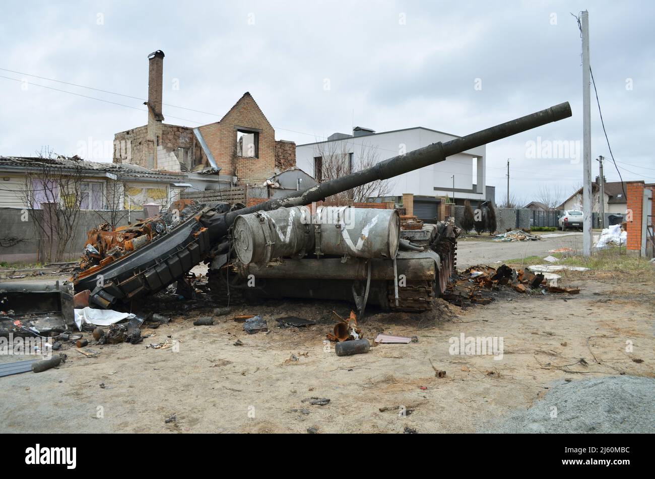 Dmytrivka village, Kyiv region, Ukraine - Apr 13, 2022: Destroyed Russian tank with a white painting V following the Ukrainian forces counter-attacks. Stock Photo