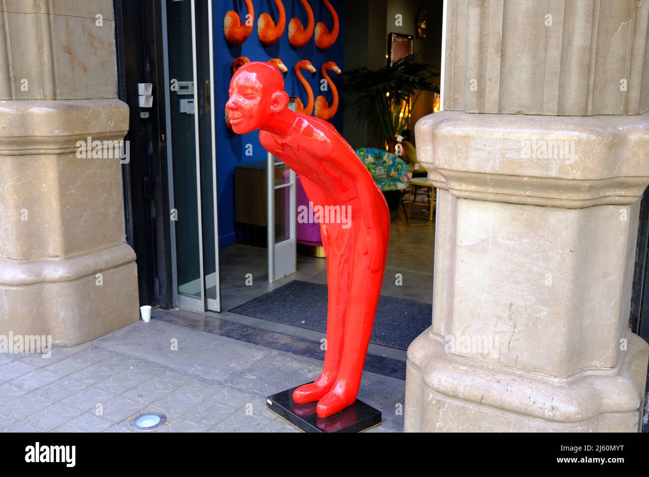 A bowing man in front of Kare Shop in Barcelona, Spain Stock Photo