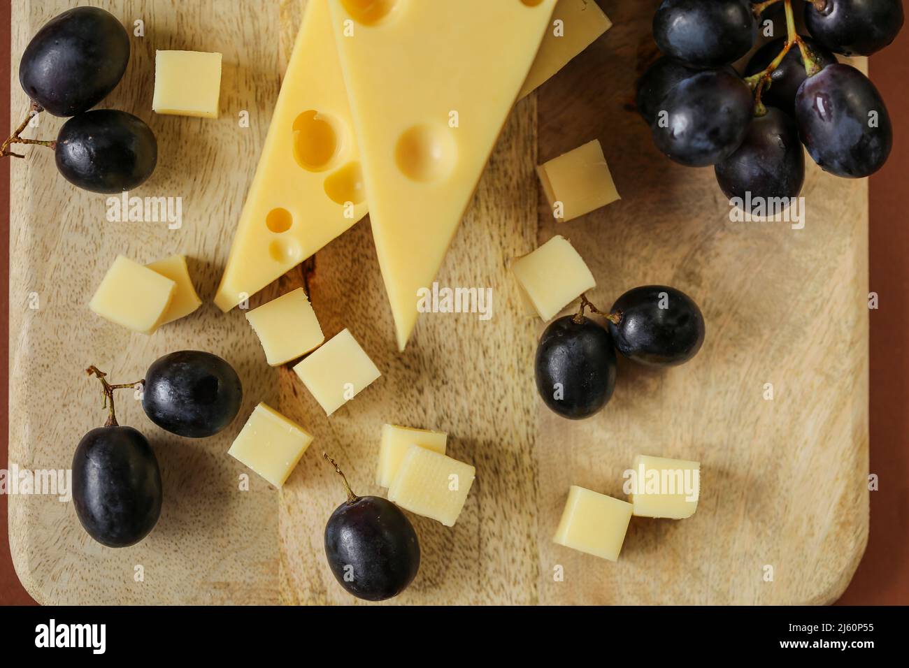 Mazdar cheese triangles, gouda cheese cubes and black grapes.Cheese