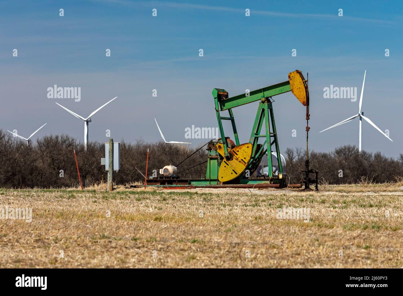 Arkansas City, Kansas - An oil well and wind turbines in southern Kansas. Stock Photo