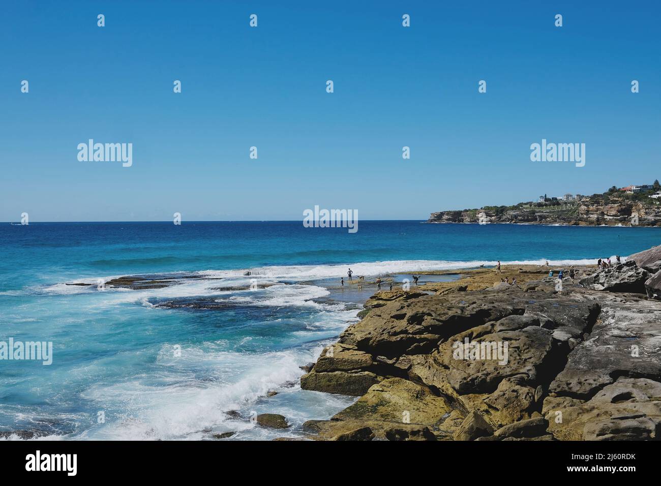 Surfers riding the waves at Tamarama Beach, on the eastern coast of Sydney, New South Wales, Australia Stock Photo