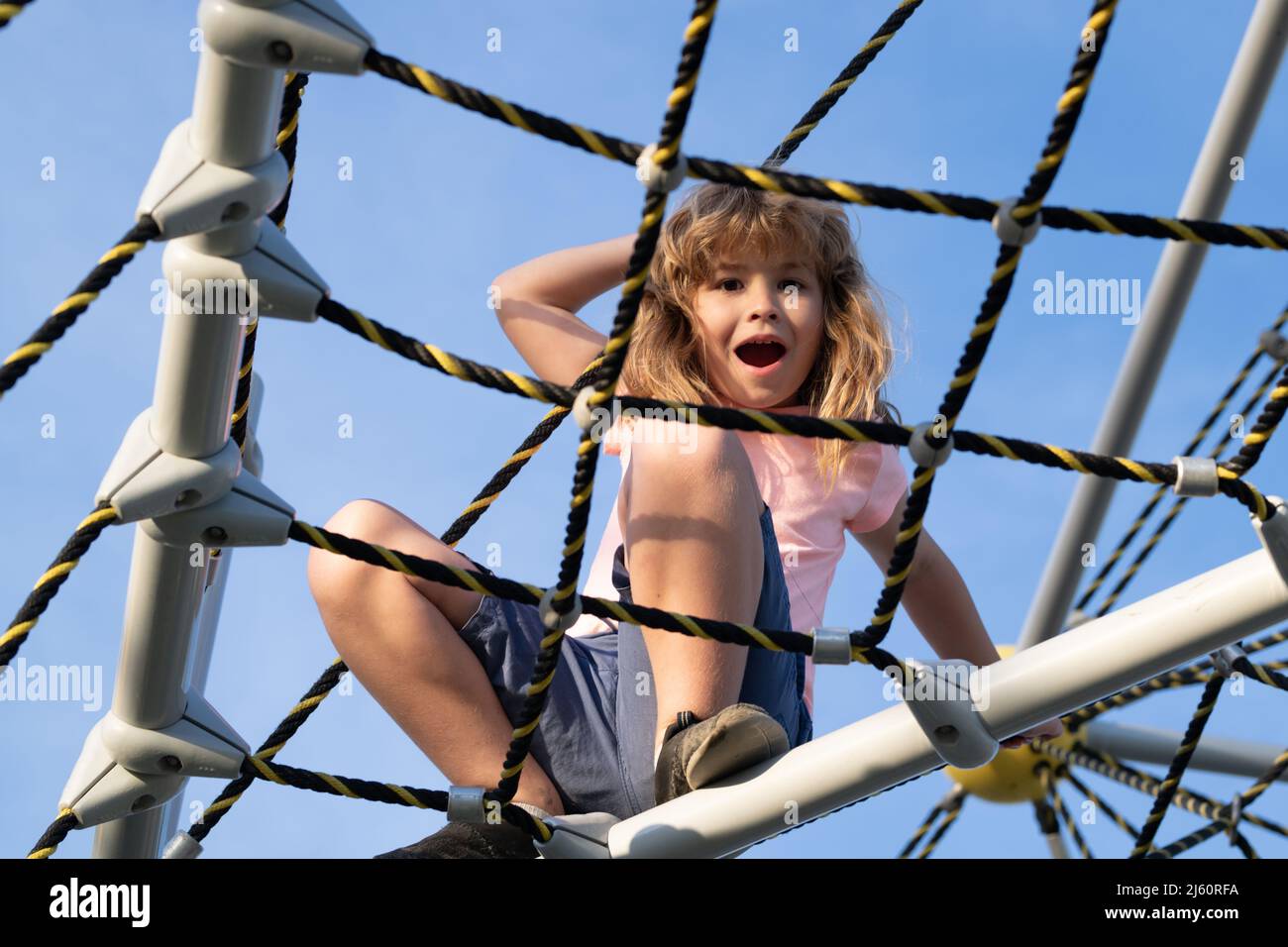 New Zealand Photos  Young boy smiling and sharing a rope swing