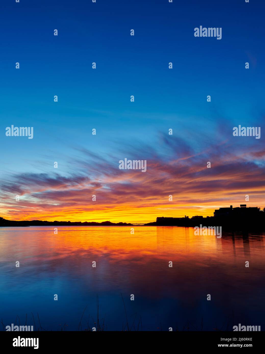 Sunset at Camp Creek Lake a coastal dune lake with Watersound development in the distance along Scenic Hwy 30a in South Walton County Florida, USA. Stock Photo