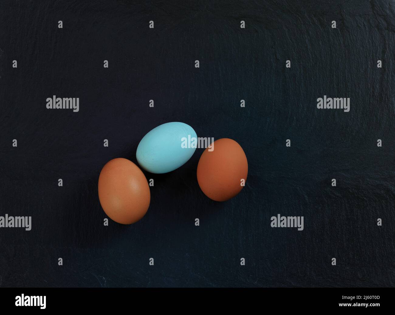 Three chicken eggs lying on natural slate stone setting Stock Photo - Alamy