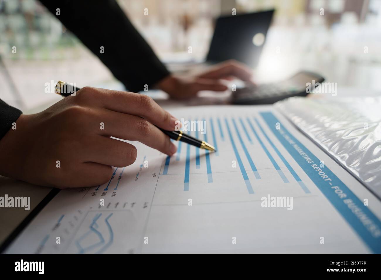 Close up Businessman hand holding pen and pointing at financial ...