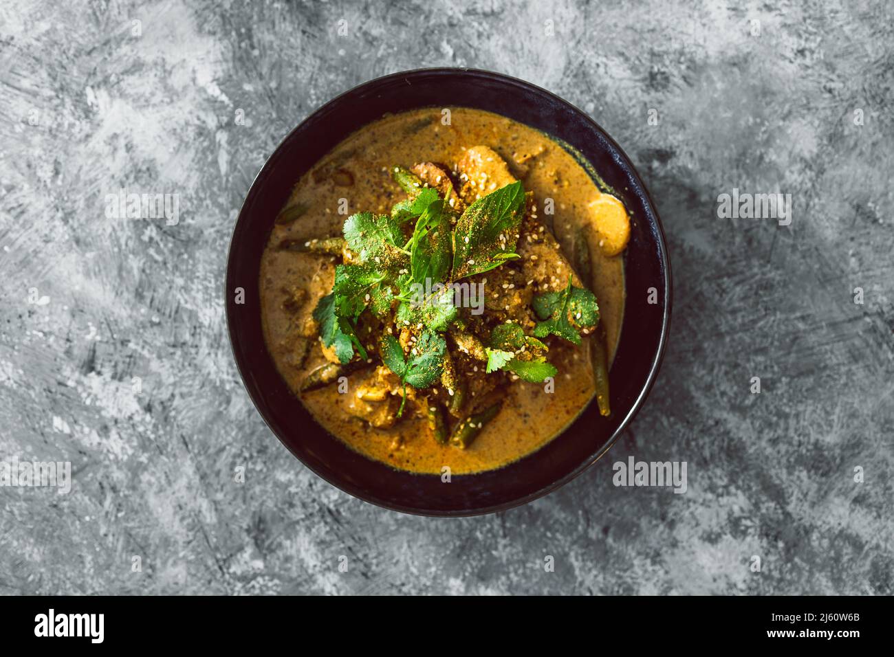 vegan tempeh curry with water chestnut green beans and fresh herbs, healthy plantbased food