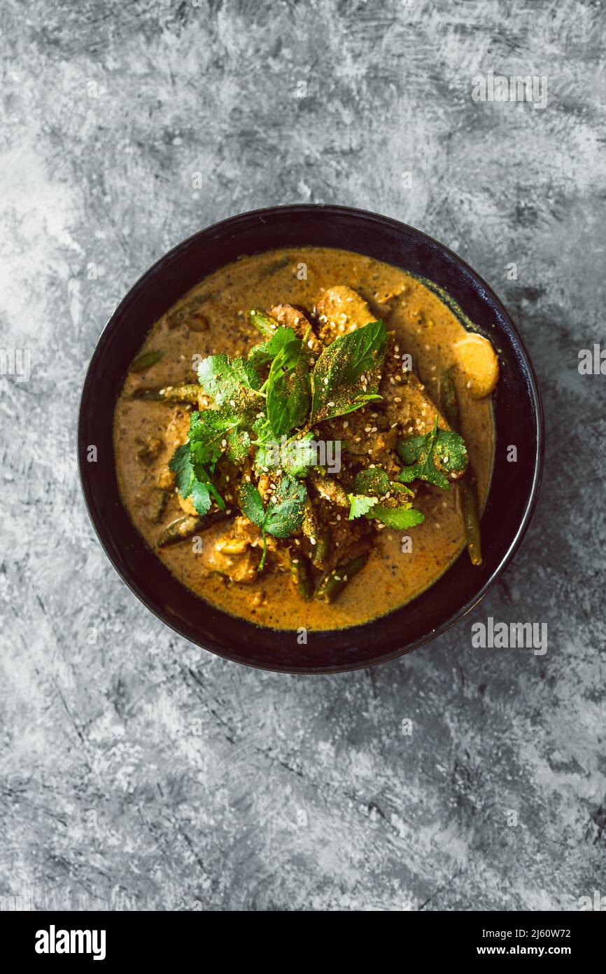 vegan tempeh curry with water chestnut green beans and fresh herbs