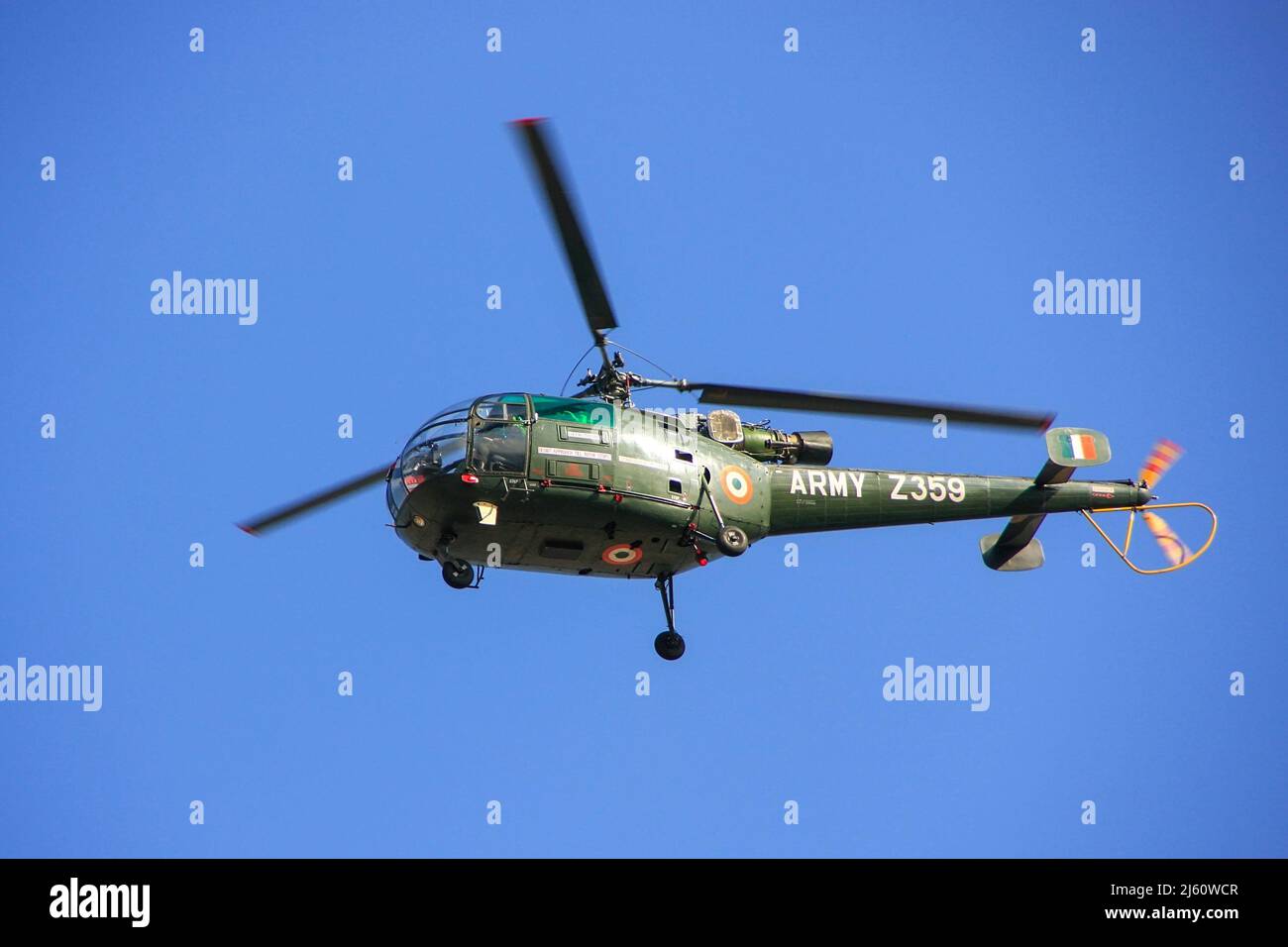 Military helicopter in blue sky, Jaipur, Rajasthan, India. The Army Aviation Corps is a component of the Indian Army, formed on 1 November 1986. Stock Photo