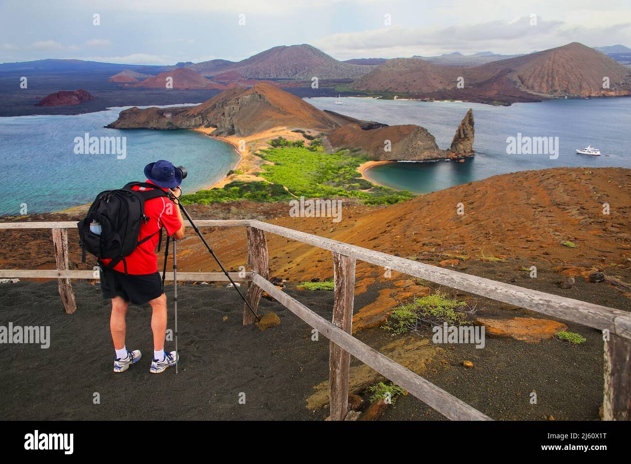 Man photographing panoramic view of Bartolome island in Galapagos National Park, Ecuador. This island offers some of the most beautiful landscapes in Stock Photo
