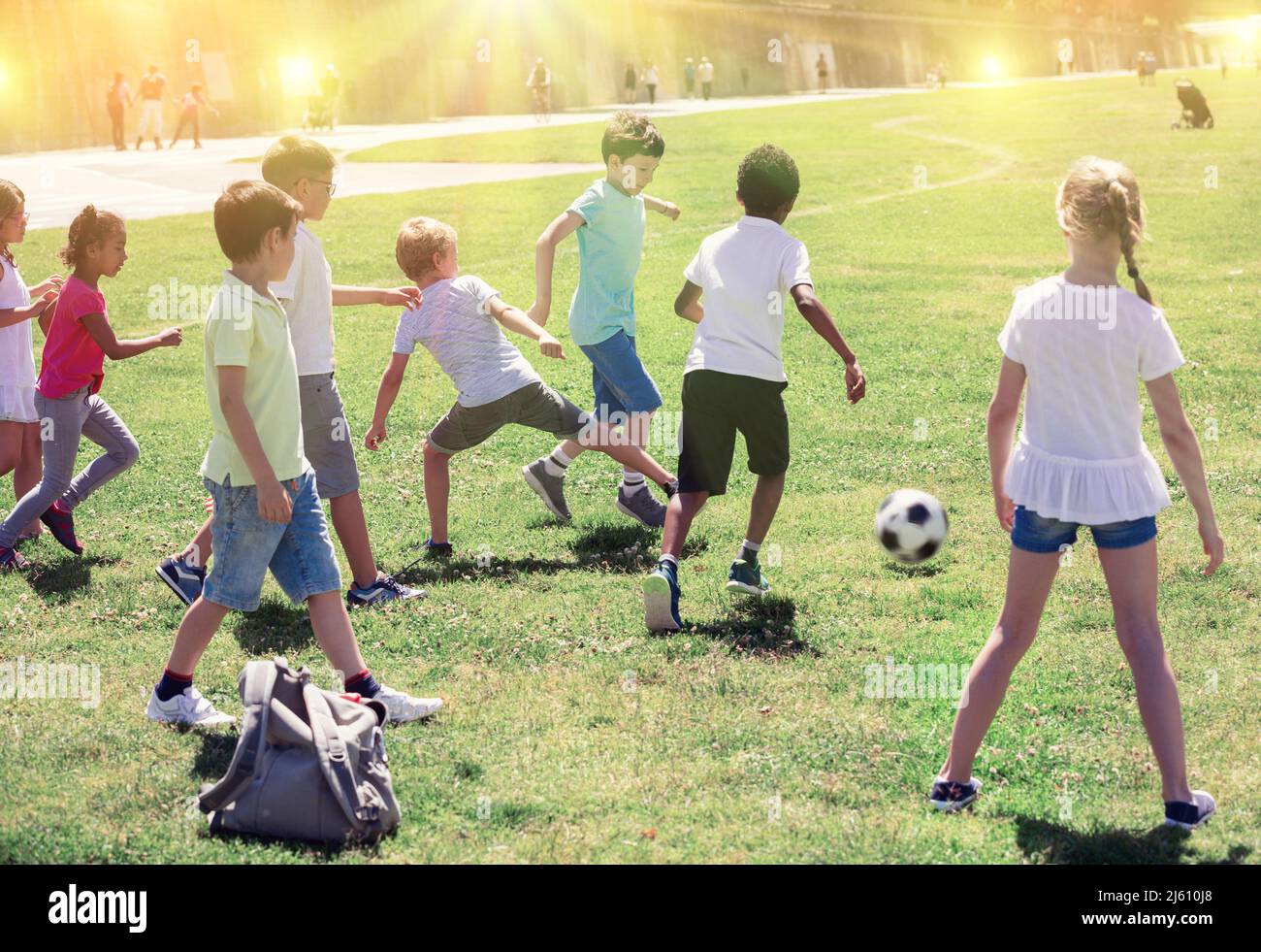 Group of kids are running and playing football in the park Stock Photo ...