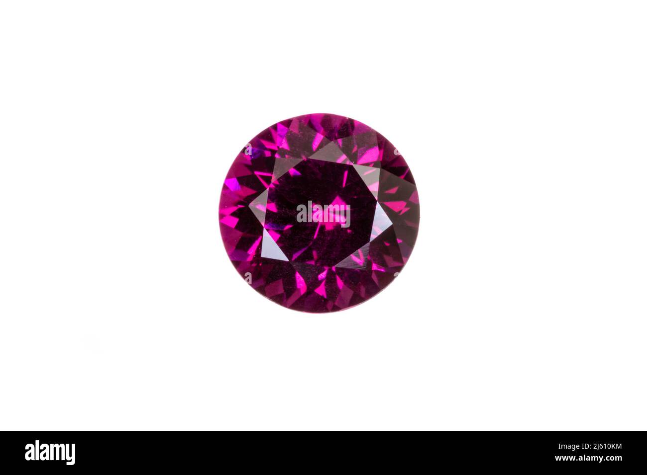 Rare grape colored garnet, top view. 6.4mm round cut, 1.35 carats. From India. White background. Stock Photo