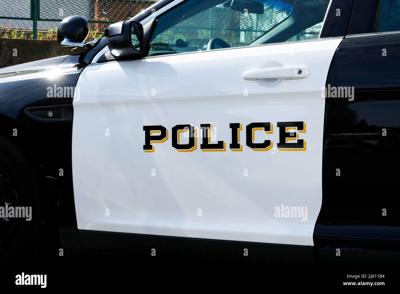 Police sign on the white door of a law enforcement vehicle. Close up. Stock Photo