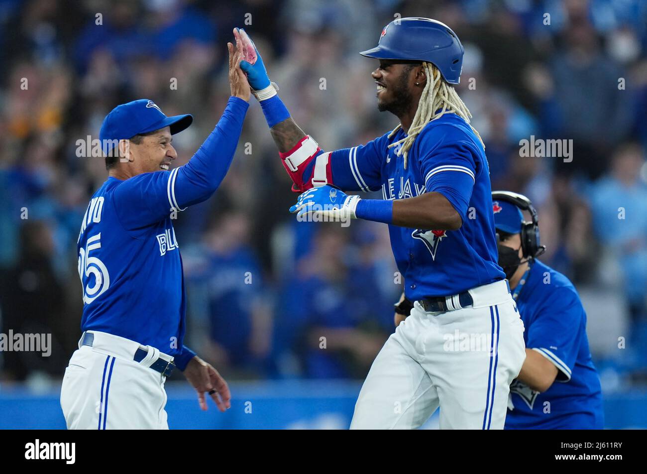Toronto, Canada, April 26, 2022, Toronto Blue Jays left fielder Raimel  Tapia (15) celebrates his game winning sacrifice RBI with Blue Jays manager  Charlie Montoyo (25) after defeating the Boston Red Sox
