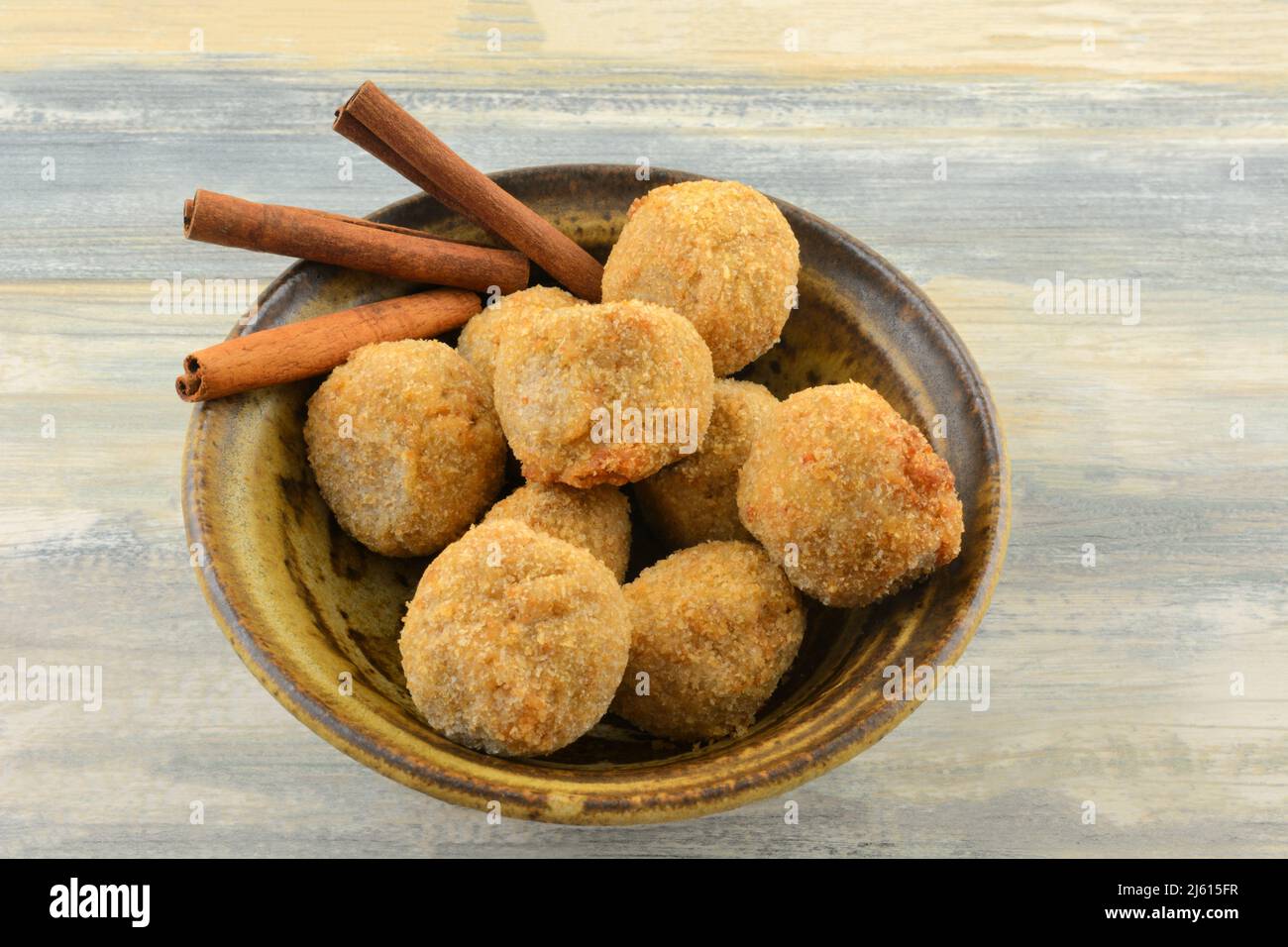 Apple cinnamon oatmeal balls with cinnamon sticks in bowl on table Stock Photo