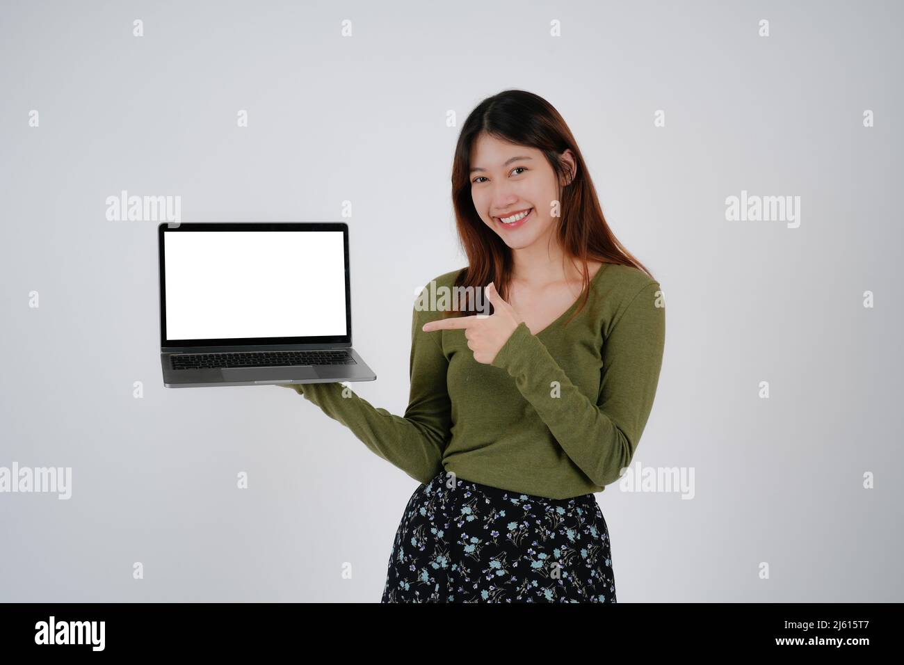 young asian girl holding a laptop and show blank white sreen, isolated ...