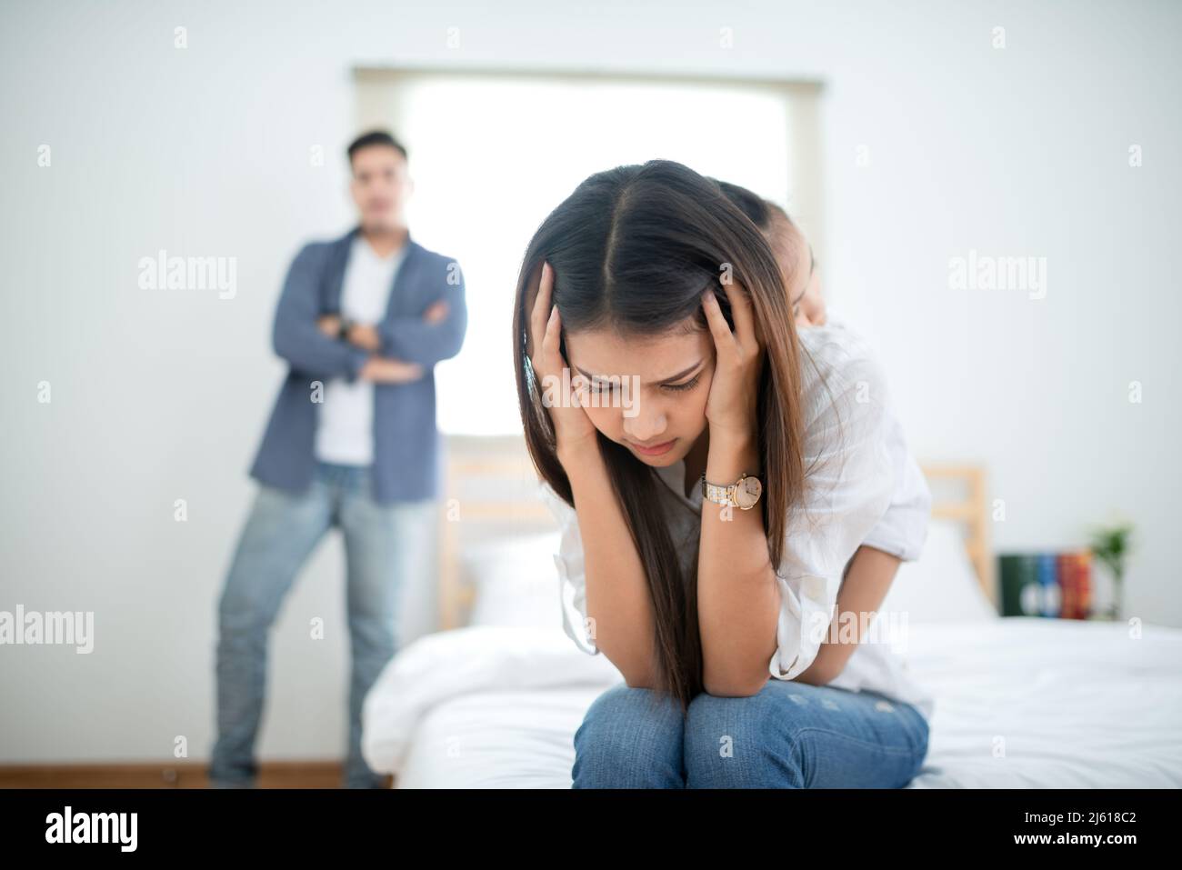 Parents arguing in front of their daughter. Family quarrel concept Stock Photo