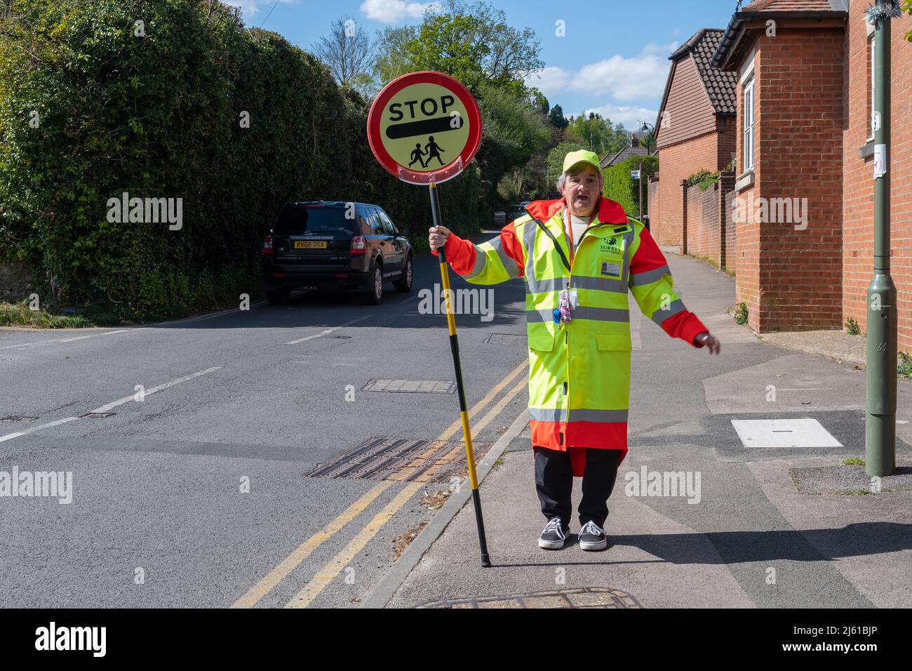 Lollipop lady, school crossing patrol officer, in Haslemere, Surrey, England, UK Stock Photo