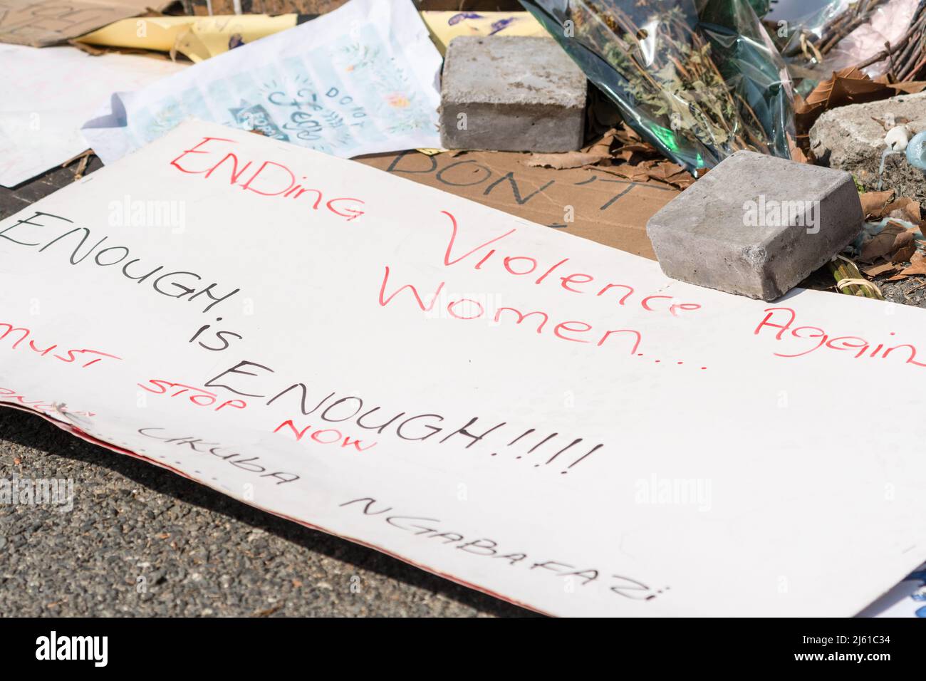 enough is enough, handwritten poster on the ground concept violence against women, gender based violence at a memorial site in Cape Town, South Africa Stock Photo