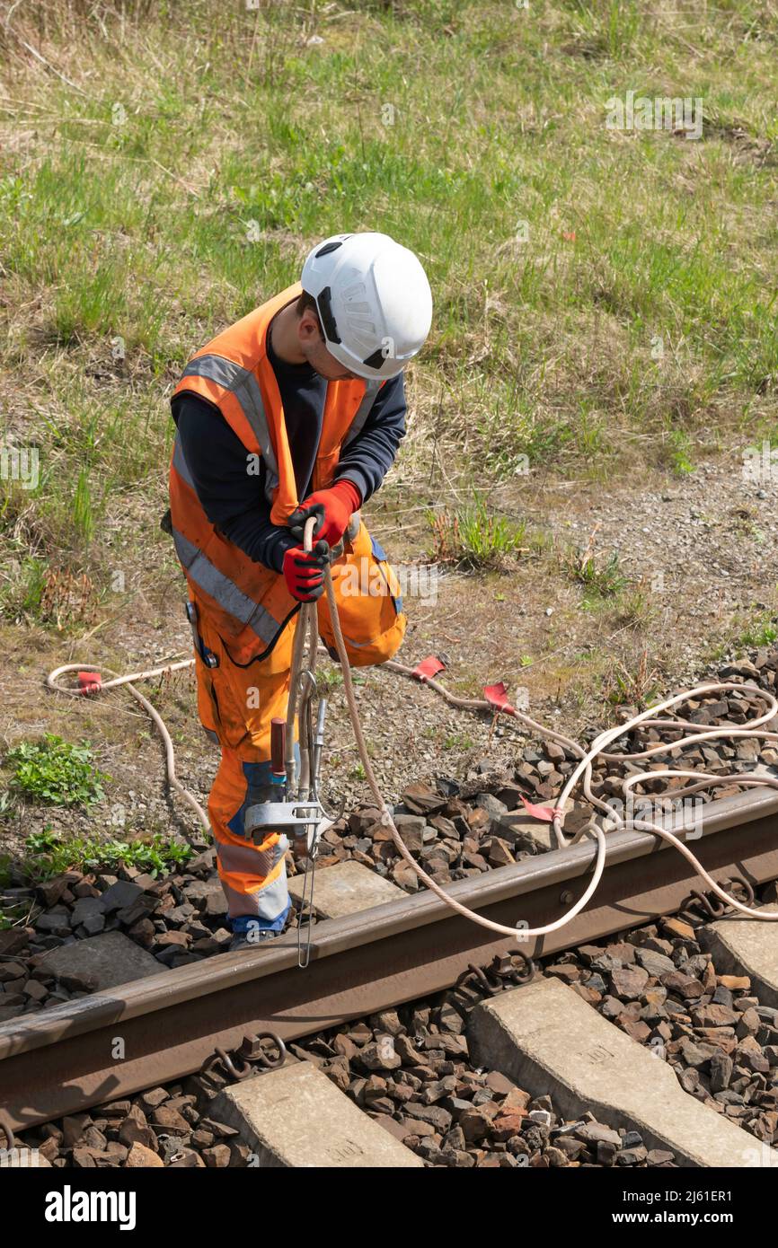 Line Workers Riding Wire An overhead line worker coils a grounding cable on Stock Photo - Alamy