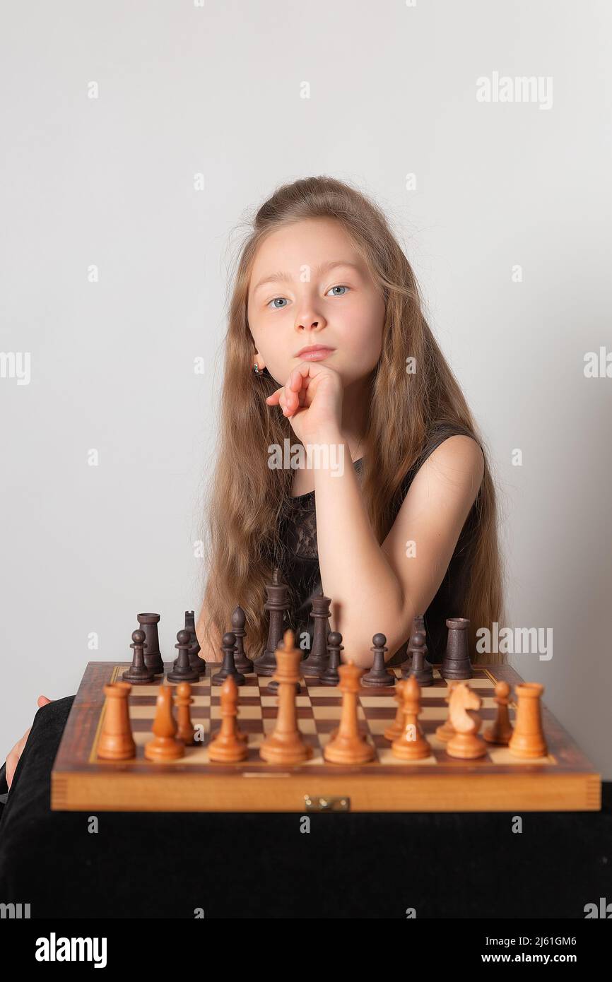 Young white child playing a game of chess on large chess board. Chess board  on table in front of school boy thinking of next move by Len44ik Vectors &  Illustrations with Unlimited