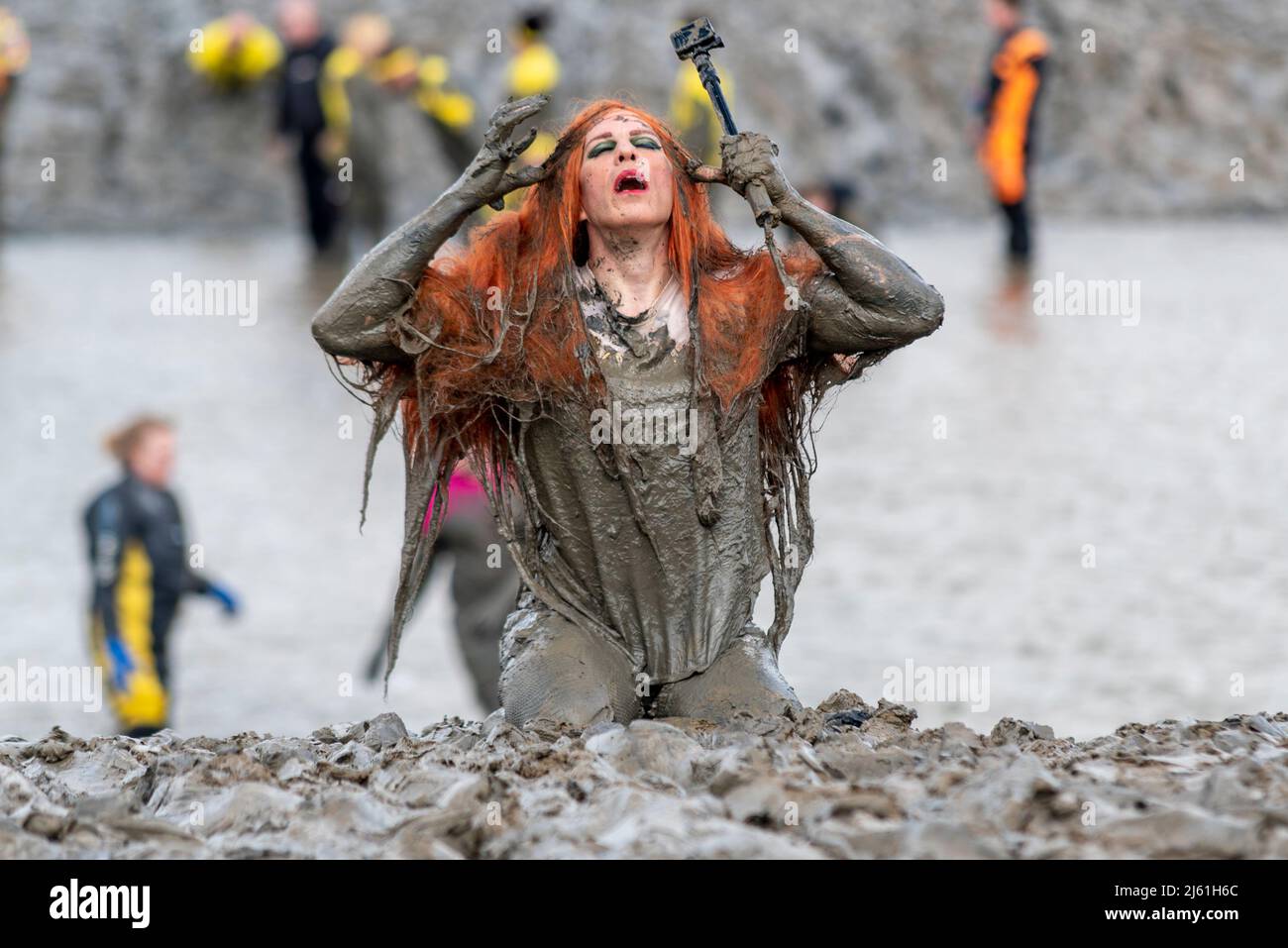 Ed Willcox, drag queen name An Nemia, at the Maldon Mud Race 2022 on the River Blackwater, Essex, UK. Covered in mud Stock Photo