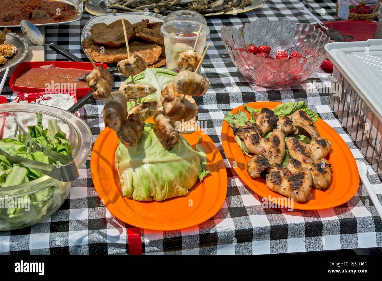 Offering food that includes barbecue, salads, strawberry toppings and more. Stock Photo